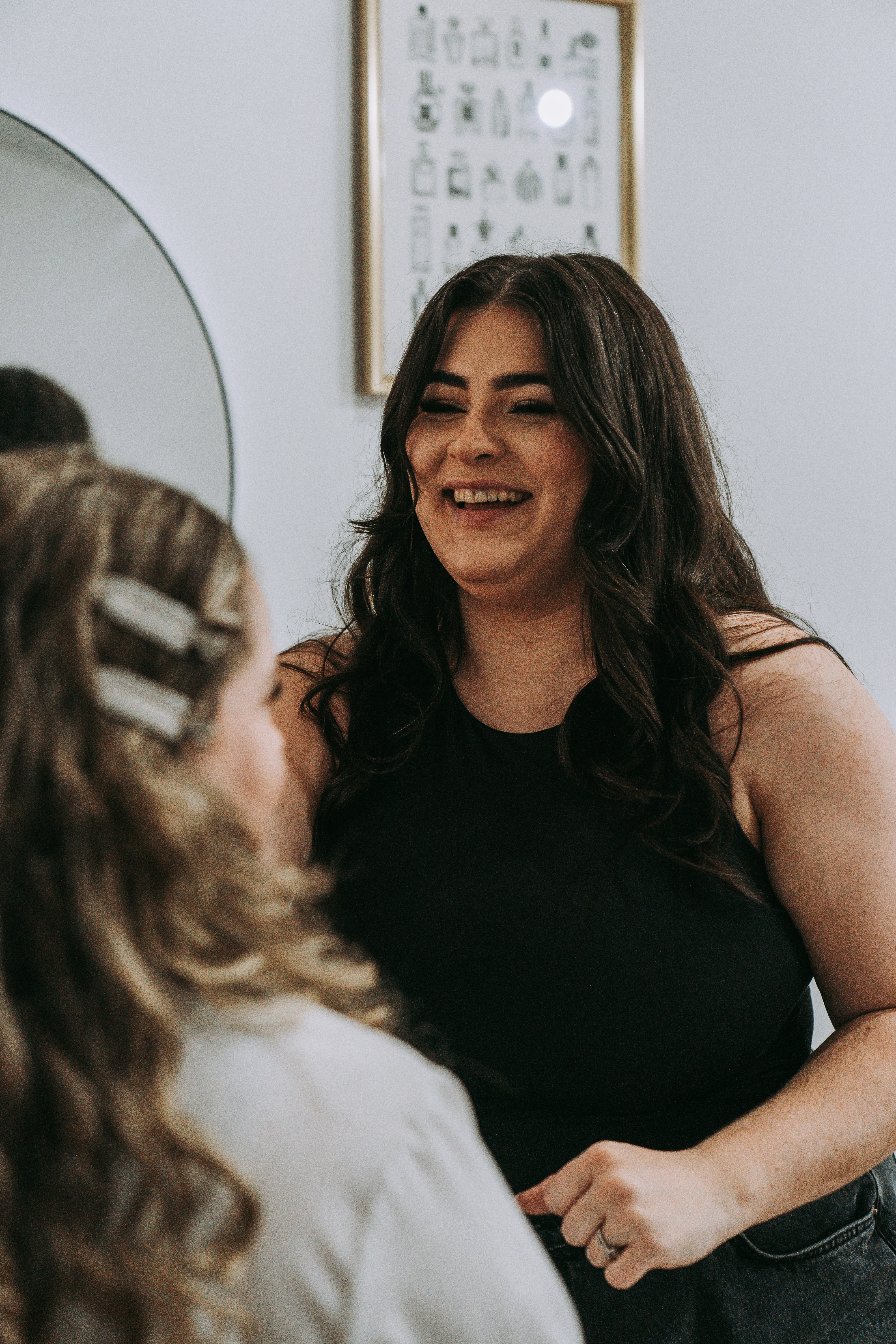 Bride applying makeup, reflected in a vintage mirror