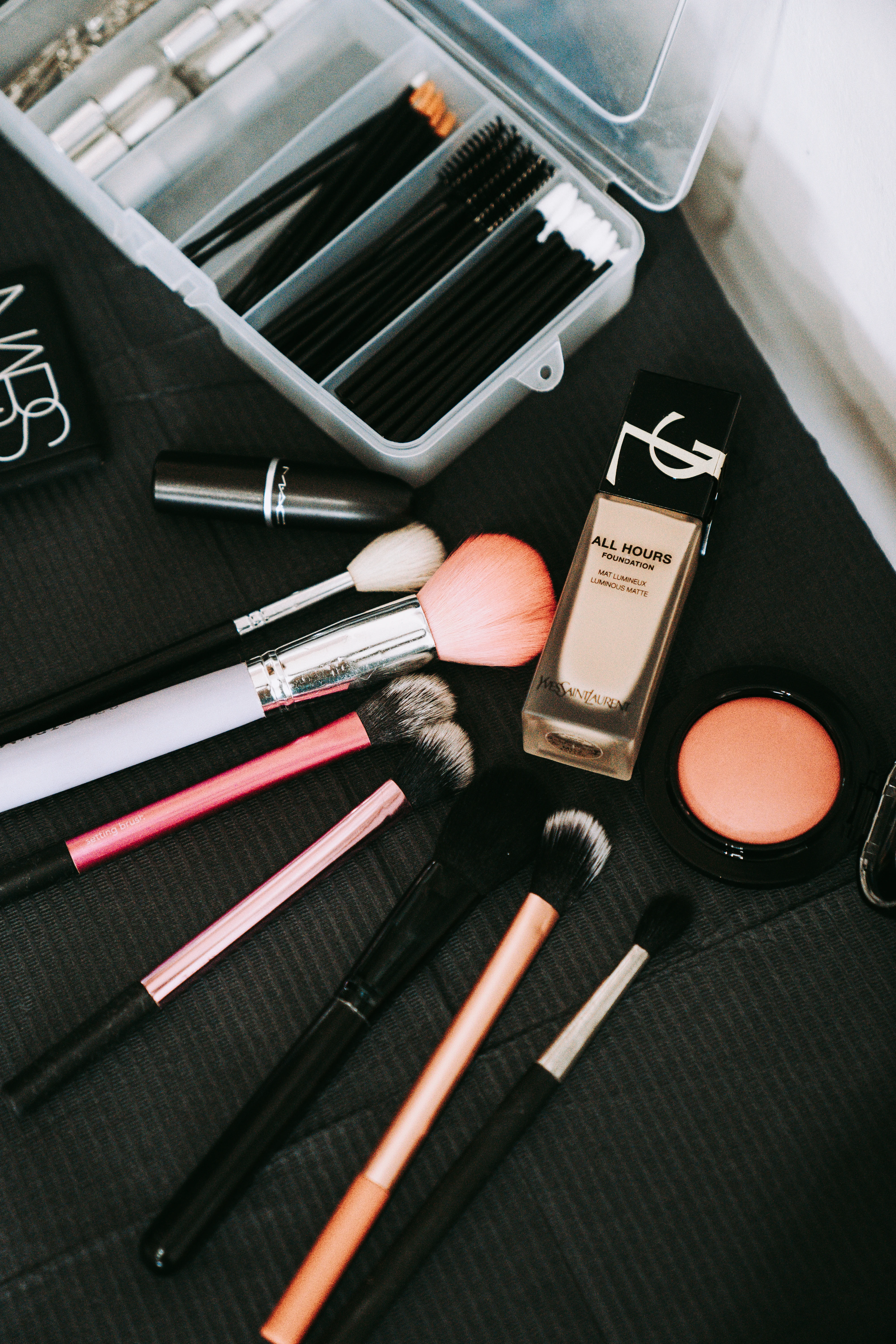 Roselli Cosmetologist's makeup kit laid flat on a dark surface, foundation, brushes, blush and disposable wands